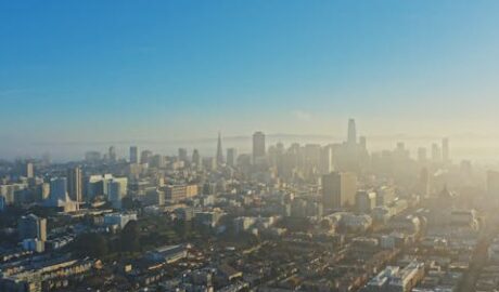 A view of Mumbai skyline covered in heavy smog and air pollution, illustrating the environmental challenges of unsustainable urban development and the urgent need for sustainable growth.